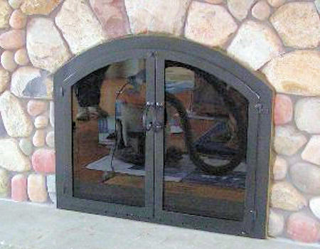 Nantucket Arch On cultured stone. All black finish, twin/cabinet style doors with standard forged handles. Comes with standard smoked glass and gate mesh.  (Mortar installation)